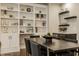 Dining room featuring a modern table, built-in shelves, hardwood floors, and neutral paint at 5254 N Park Ave, Indianapolis, IN 46220