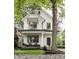 Charming two-story modern farmhouse featuring black window trim and inviting front porch at 5254 N Park Ave, Indianapolis, IN 46220