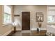 Bright and airy foyer featuring a decorative wooden door, hardwood floors, and stylish decor at 5254 N Park Ave, Indianapolis, IN 46220