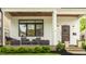 Inviting front porch with seating, stylish lighting, and beautifully landscaped surroundings at 5254 N Park Ave, Indianapolis, IN 46220