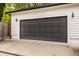 Detached garage has gray carriage door, white siding, and vintage outdoor lighting at 5254 N Park Ave, Indianapolis, IN 46220