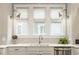 Kitchen sink featuring chevron backsplash, under cabinet lighting, modern faucet, and stainless steel dishwasher at 5254 N Park Ave, Indianapolis, IN 46220