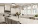 Bright kitchen featuring a large island, white cabinets, stainless steel appliances, and chevron patterned backsplash at 5254 N Park Ave, Indianapolis, IN 46220
