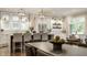 Bright open-concept kitchen with stainless steel appliances, bar seating, and modern lighting at 5254 N Park Ave, Indianapolis, IN 46220