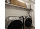 Convenient laundry room features modern washer and dryer and shelf space for storage at 5254 N Park Ave, Indianapolis, IN 46220