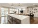 Open concept living room and kitchen area featuring modern furniture, white trim, and hardwood floors at 5254 N Park Ave, Indianapolis, IN 46220