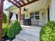 Covered back patio featuring a brick foundation, outdoor seating, and access to the landscaped backyard at 5347 Sampson Dr, Indianapolis, IN 46237