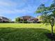 Spacious backyard featuring a large lawn, a pergola, and well-maintained landscaping, creating a private outdoor oasis at 5347 Sampson Dr, Indianapolis, IN 46237