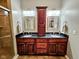 Bathroom featuring double sink vanity with granite countertop, framed mirrors, and glass-enclosed shower at 5347 Sampson Dr, Indianapolis, IN 46237