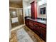 Bathroom showcasing double sink vanity with granite countertop, framed mirrors, decorative lighting, and glass-enclosed shower at 5347 Sampson Dr, Indianapolis, IN 46237