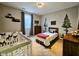 Charming bedroom with a crib, twin bed, natural light, and woodland-themed decor at 5347 Sampson Dr, Indianapolis, IN 46237