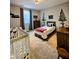 A Bedroom shows a baby bed alongside a bed against a backdrop of themed wall decor at 5347 Sampson Dr, Indianapolis, IN 46237