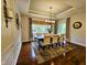Formal dining room featuring hardwood floors, a coffered ceiling, and an elegant chandelier at 5347 Sampson Dr, Indianapolis, IN 46237
