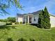 A charming single-story white brick home has a beautifully landscaped yard at 5347 Sampson Dr, Indianapolis, IN 46237