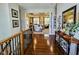 Foyer with hardwood floors, decorative columns and railing, and an open view into the living room at 5347 Sampson Dr, Indianapolis, IN 46237