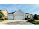 A white brick home has a two car garage, a well manicured front lawn, and a large driveway at 5347 Sampson Dr, Indianapolis, IN 46237