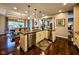 Bright kitchen with a central island, granite countertops, stainless steel appliances, and hardwood floors at 5347 Sampson Dr, Indianapolis, IN 46237