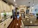 A gourmet kitchen boasts beautiful cream cabinetry, granite countertops, stainless steel appliances, and hardwood flooring at 5347 Sampson Dr, Indianapolis, IN 46237