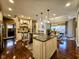 Bright kitchen with a central island, granite countertops, stainless steel appliances, and hardwood floors at 5347 Sampson Dr, Indianapolis, IN 46237