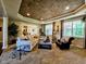 Spacious living room featuring tray ceiling, neutral color palette, and large windows offering an abundance of natural light at 5347 Sampson Dr, Indianapolis, IN 46237