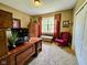 Spacious office with natural light, a comfortable seating area, and custom built-in shelving at 5347 Sampson Dr, Indianapolis, IN 46237