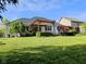 Outdoor patio with a stylish pergola, ideal for relaxing and entertaining, surrounded by a lush green lawn at 5347 Sampson Dr, Indianapolis, IN 46237
