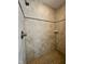 Shower featuring stone tile, showerhead, and soap ledge at 5347 Sampson Dr, Indianapolis, IN 46237