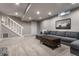 Finished basement with stairs, modern sofa, decorative pillows, and neutral carpeting at 5430 N Washington Blvd, Indianapolis, IN 46220