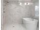 Bathroom featuring marble tile, a shower with multiple shower heads, and a soaking tub at 5430 N Washington Blvd, Indianapolis, IN 46220