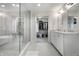Bright bathroom with a walk-in closet, dual sinks, and a glass-enclosed shower with a separate soaking tub at 5430 N Washington Blvd, Indianapolis, IN 46220