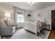 Bright bedroom featuring a white bed frame, neutral walls and a decorative rug with a chair at 5430 N Washington Blvd, Indianapolis, IN 46220