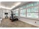 Light-filled exercise room with an elliptical trainer, free weights, and shuttered windows at 5430 N Washington Blvd, Indianapolis, IN 46220