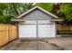 Two-car garage featuring white doors, a brick facade, and a terracotta roof at 5430 N Washington Blvd, Indianapolis, IN 46220
