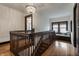 Hallway with hardwood floors, a wooden banister, a window seat, and modern lighting at 5430 N Washington Blvd, Indianapolis, IN 46220