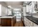 Bright kitchen with stainless steel appliances, a marble island, and access to the backyard at 5430 N Washington Blvd, Indianapolis, IN 46220