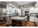 Updated kitchen featuring a marble island, modern appliances, and custom cabinetry at 5430 N Washington Blvd, Indianapolis, IN 46220