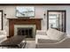 Charming living room showcasing a fireplace with green tiles, a painting above, and white sofas at 5430 N Washington Blvd, Indianapolis, IN 46220