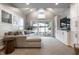 Bright living room with vaulted ceiling, a plush sectional, and sliding doors to the patio at 5430 N Washington Blvd, Indianapolis, IN 46220