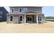 Backyard of a two-story house featuring a covered patio and newly laid sod at 5517 Sienna Ct, Brownsburg, IN 46112