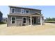 Exterior shot of a two-story home featuring a covered patio and freshly laid sod at 5517 Sienna Ct, Brownsburg, IN 46112