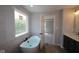 Bathroom featuring a freestanding tub, elegant tile, and a backyard view at 5517 Sienna Ct, Brownsburg, IN 46112
