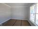 Clean bedroom space with a large window, offering ample natural light and a neutral backdrop for personal touches at 5517 Sienna Ct, Brownsburg, IN 46112