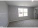 Bright bedroom featuring a large window and neutral carpeting at 5517 Sienna Ct, Brownsburg, IN 46112
