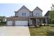 Charming two-story home with a three-car garage and a beautifully landscaped front yard at 5517 Sienna Ct, Brownsburg, IN 46112