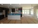 Open-concept kitchen boasts dark cabinets, island, and seamless connection to living space at 5517 Sienna Ct, Brownsburg, IN 46112