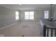 Unfinished living room with multiple windows and decorative chandelier at 5517 Sienna Ct, Brownsburg, IN 46112