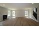 Spacious living room features a fireplace and a staircase, awaiting flooring and final touches at 5517 Sienna Ct, Brownsburg, IN 46112
