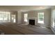 Open-concept living area featuring a fireplace and large windows, perfect for natural light and entertaining at 5517 Sienna Ct, Brownsburg, IN 46112