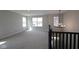 Loft area featuring neutral carpeting and ample natural light at 5517 Sienna Ct, Brownsburg, IN 46112