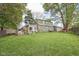 Expansive backyard features lush green grass, mature trees, and the home's exterior at 6210 Mckinley Ct, Indianapolis, IN 46220